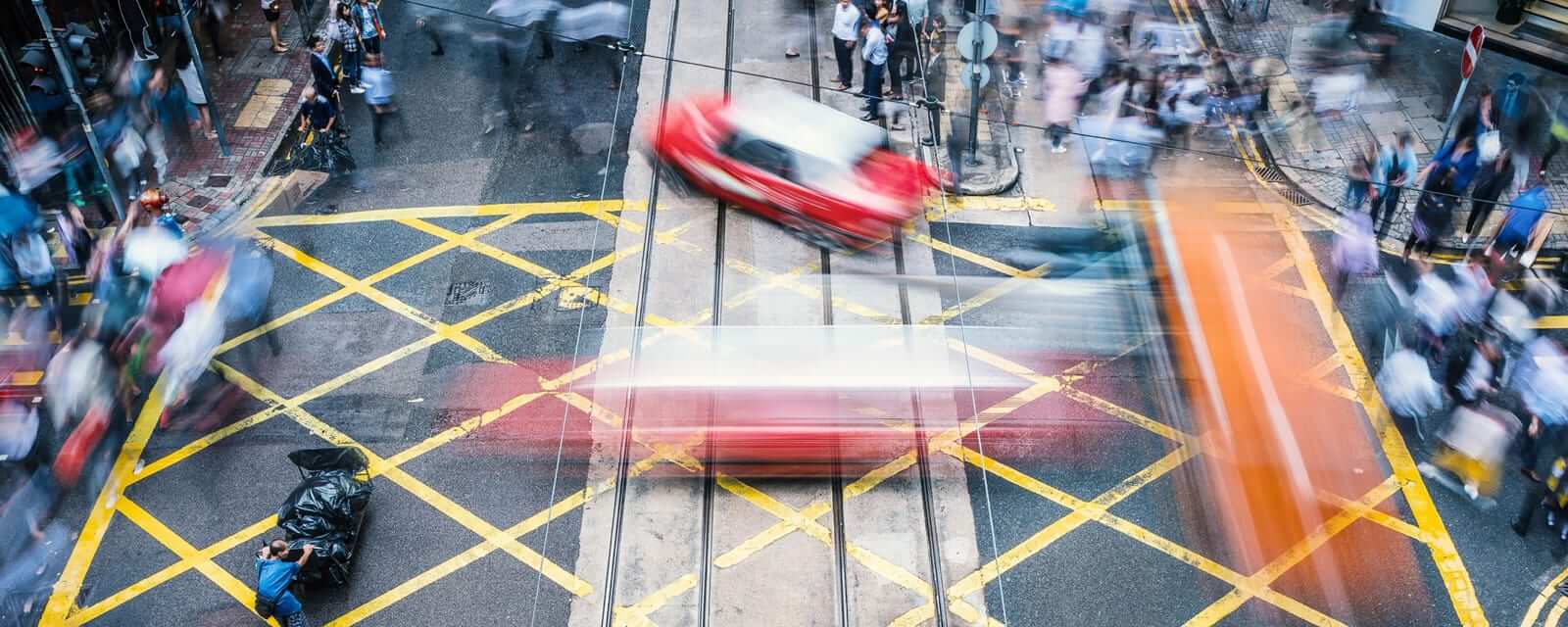 People and taxi cabs crossing a very busy crossroads in the central district, Hong Kong, China